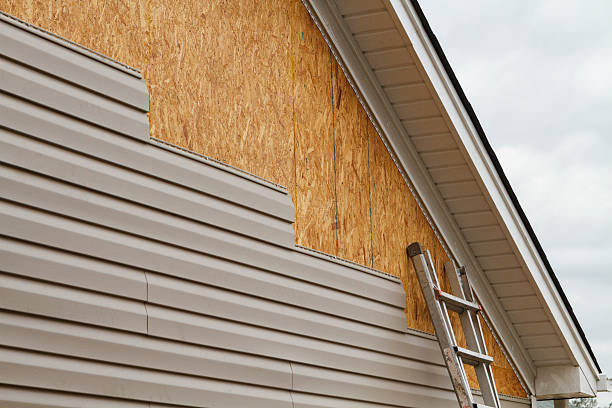 Professional Storm Damage Siding Repair technician working in Greensburg, PA